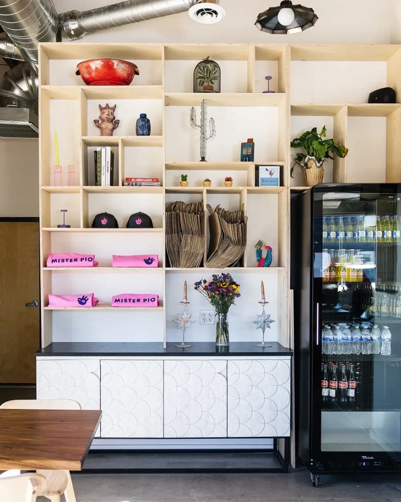 shelves of merchandise and a fridge with drinks